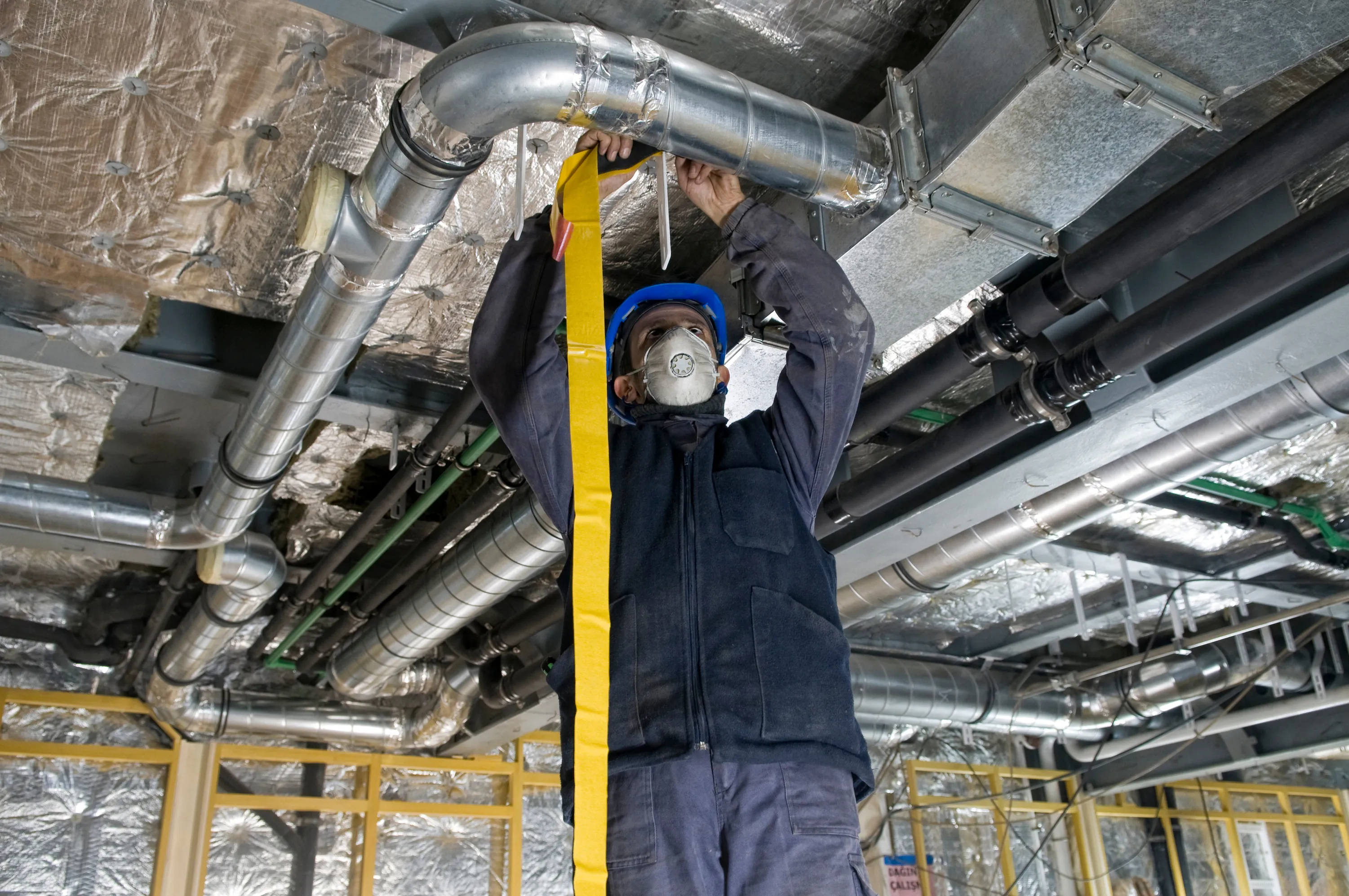 Mechanical contractor installing ductwork